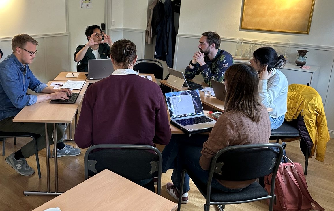 Lab members collaborating around a round table